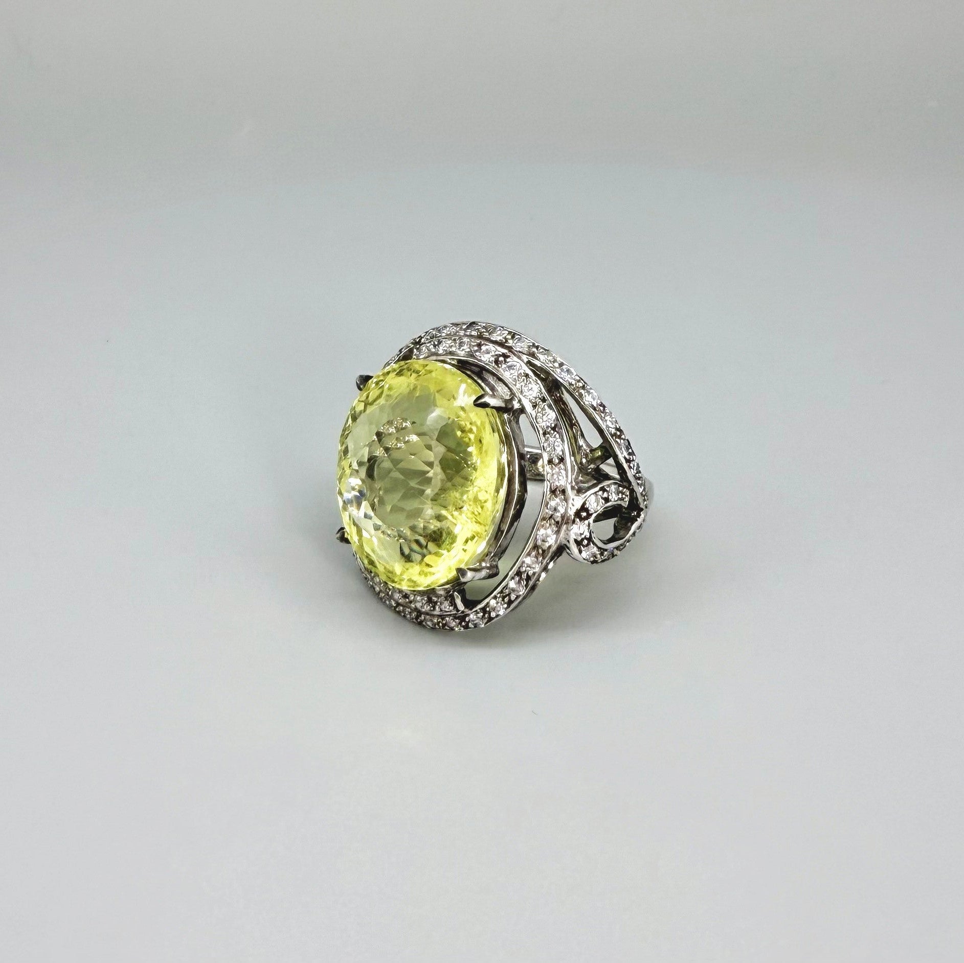 Lemon quartz and CZ ring in white gold plated sterling silver, featuring a faceted yellow gemstone framed by clear cubic zirconia, elegant and radiant design.