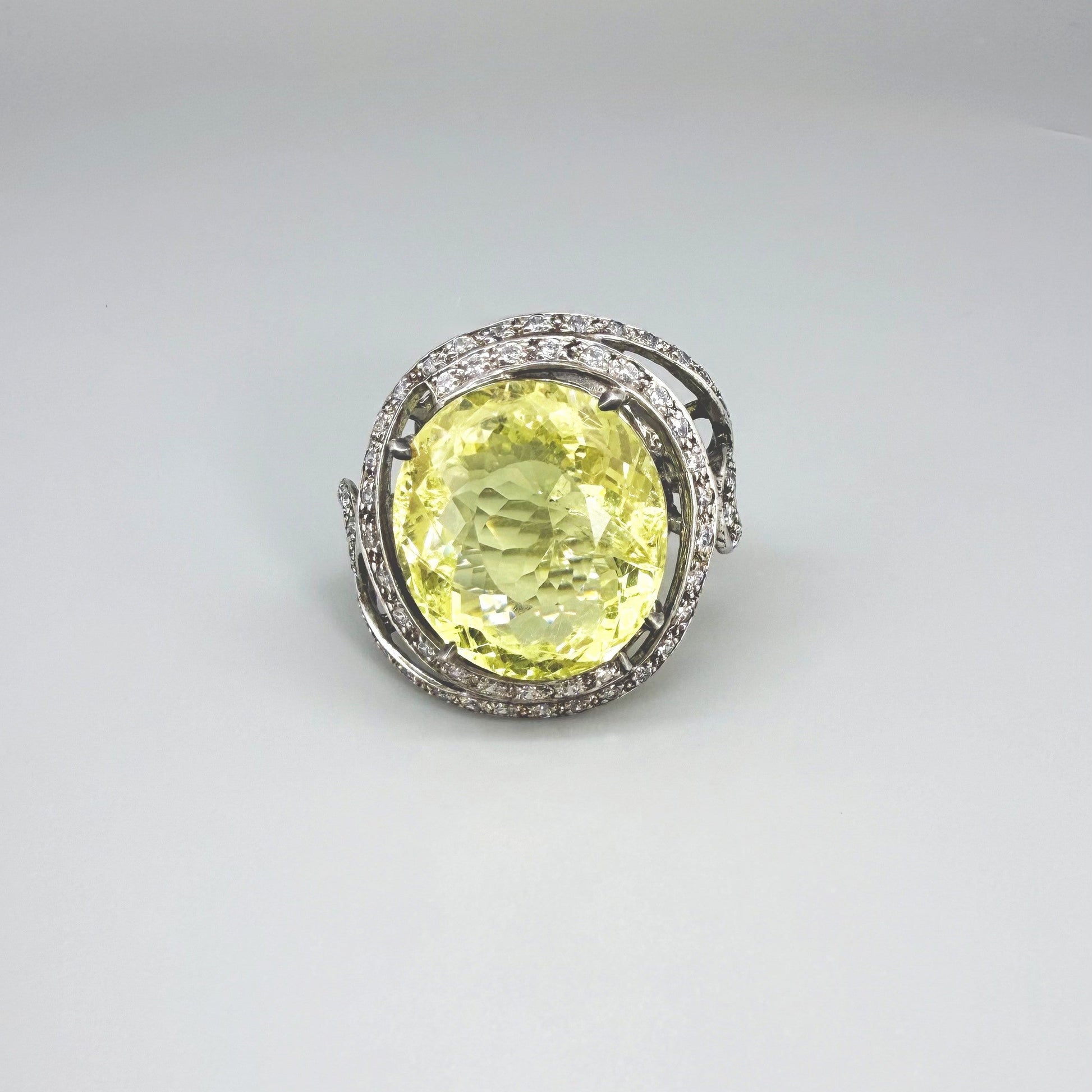 Lemon quartz and CZ ring in white gold plated sterling silver, featuring a faceted yellow gemstone framed by clear cubic zirconia, elegant and radiant design.