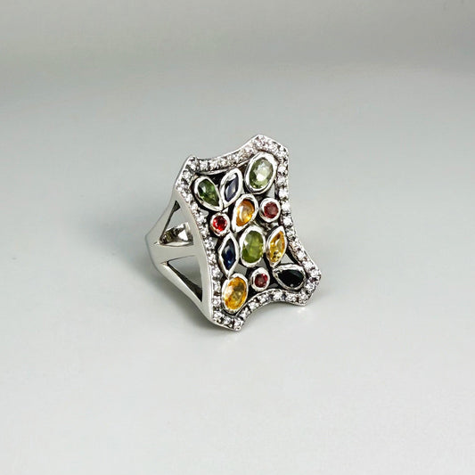 Multigemstone ring in white gold plated sterling silver, featuring sapphires, topaz, tourmalines and spinels in geometric design, colorful and elegant.