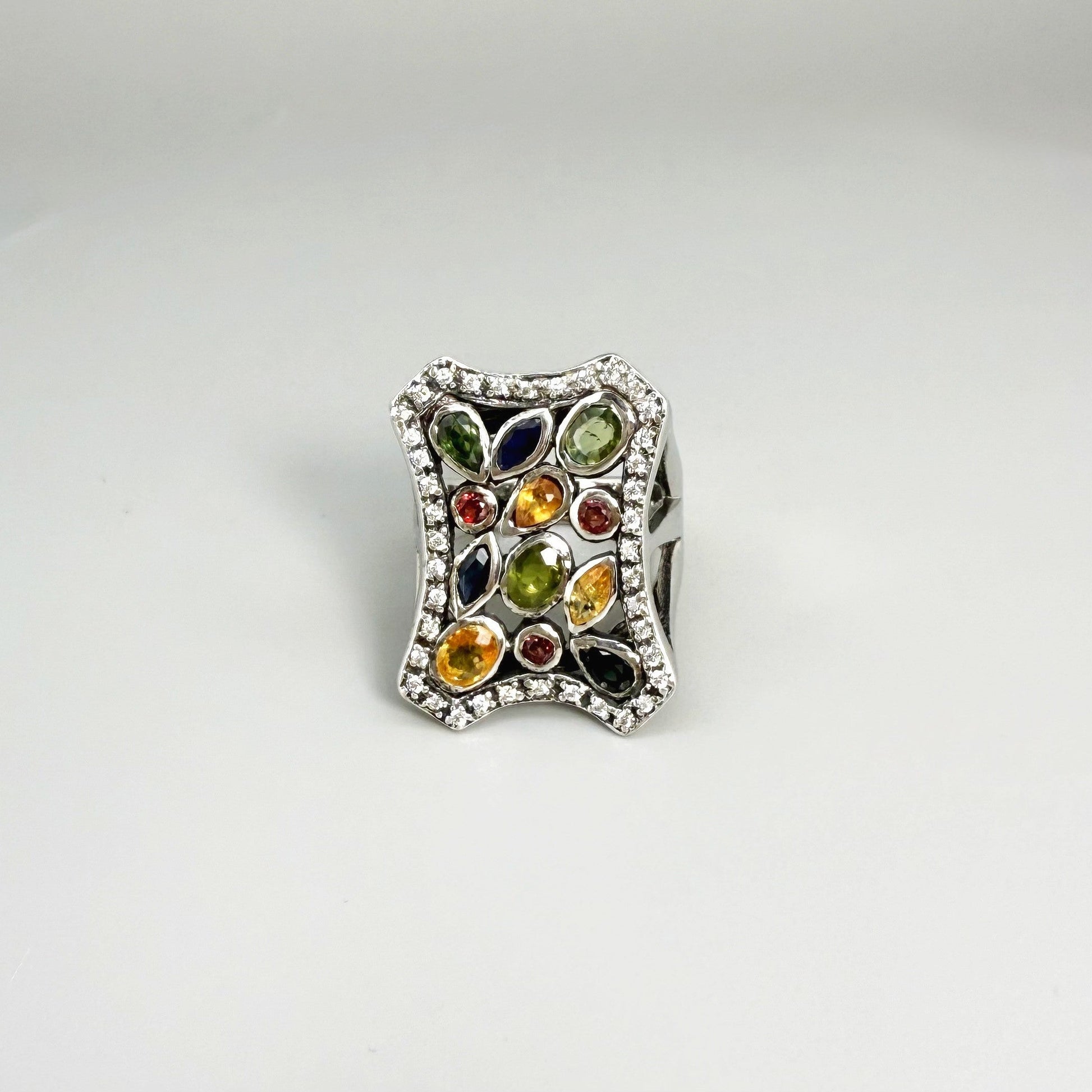 Multigemstone ring in white gold plated sterling silver, featuring sapphires, topaz, tourmalines and spinels in geometric design, colorful and elegant.