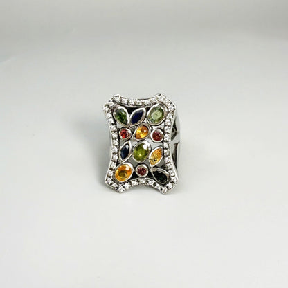 Multigemstone ring in white gold plated sterling silver, featuring sapphires, topaz, tourmalines and spinels in geometric design, colorful and elegant.