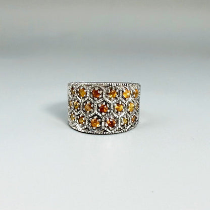Wide band orange sapphire ring in white gold plated sterling silver featuring faceted sapphires in bright amber hues for a warm, elegant shine.