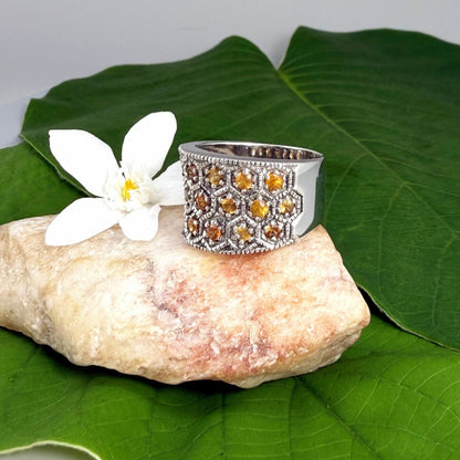 Wide band orange sapphire ring in white gold plated sterling silver featuring faceted sapphires in bright amber hues for a warm, elegant shine.