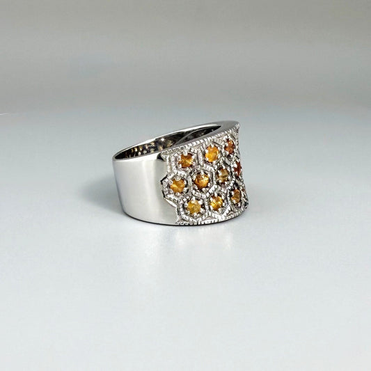 Wide band orange sapphire ring in white gold plated sterling silver featuring faceted sapphires in bright amber hues for a warm, elegant shine.