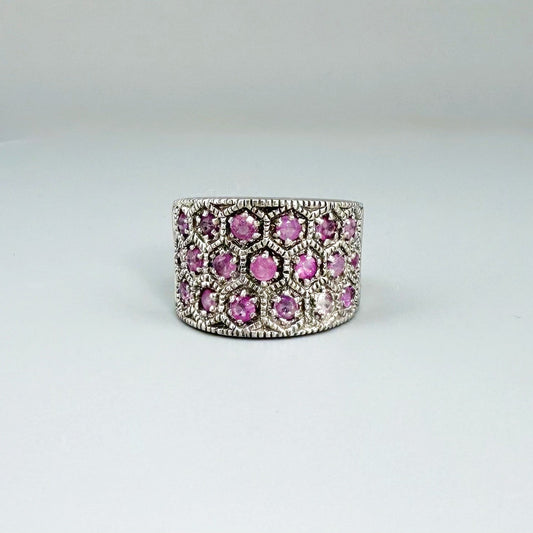 Ruby band ring in white gold plated sterling silver, featuring faceted natural red gemstones in a wide band design, elegant and luxurious style.