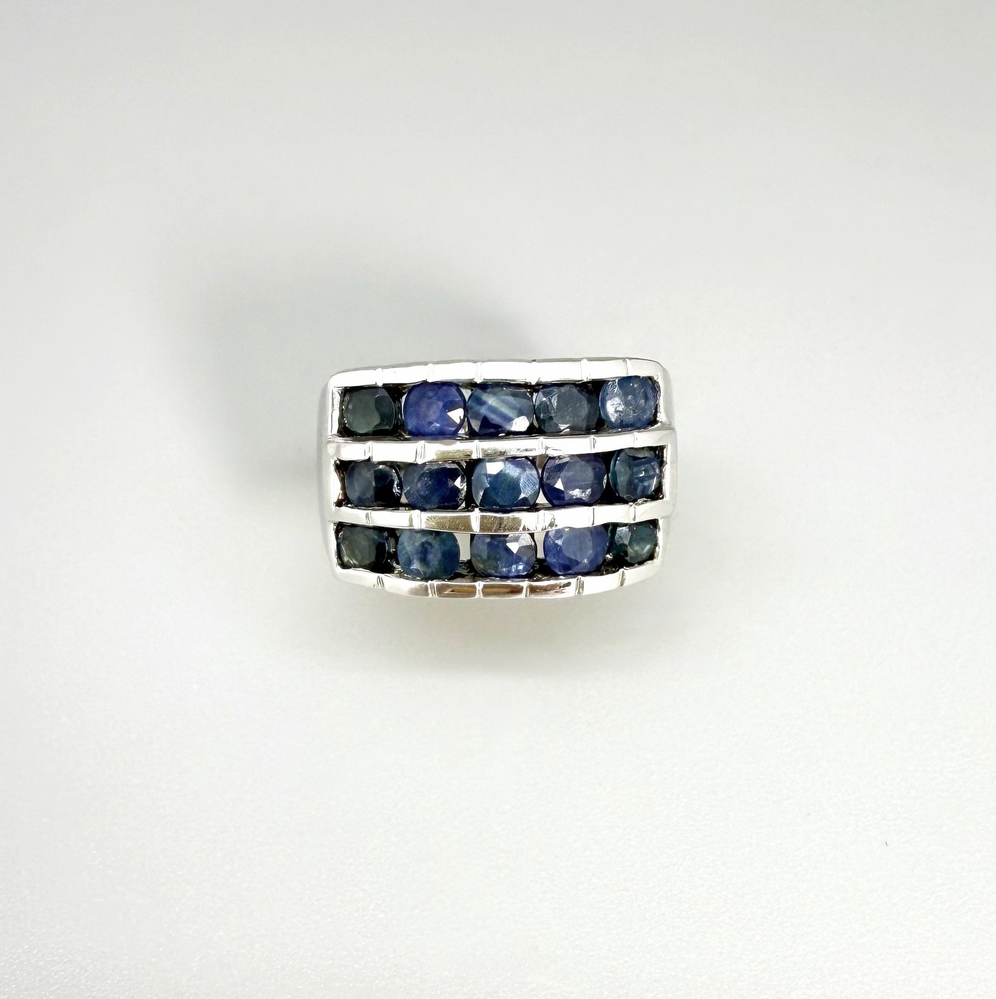 Sapphire band ring in white gold plated sterling silver, featuring three rows of natural deep blue gemstones, elegant and timeless design.