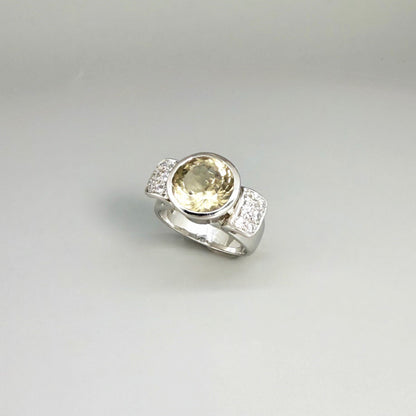 Citrine and CZ ring in white gold plated sterling silver, featuring a faceted golden gemstone with sparkling accents along the band, elegant and radiant design.