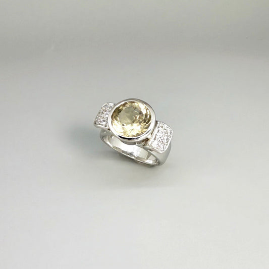 Citrine and CZ ring in white gold plated sterling silver, featuring a faceted golden gemstone with sparkling accents along the band, elegant and radiant design.