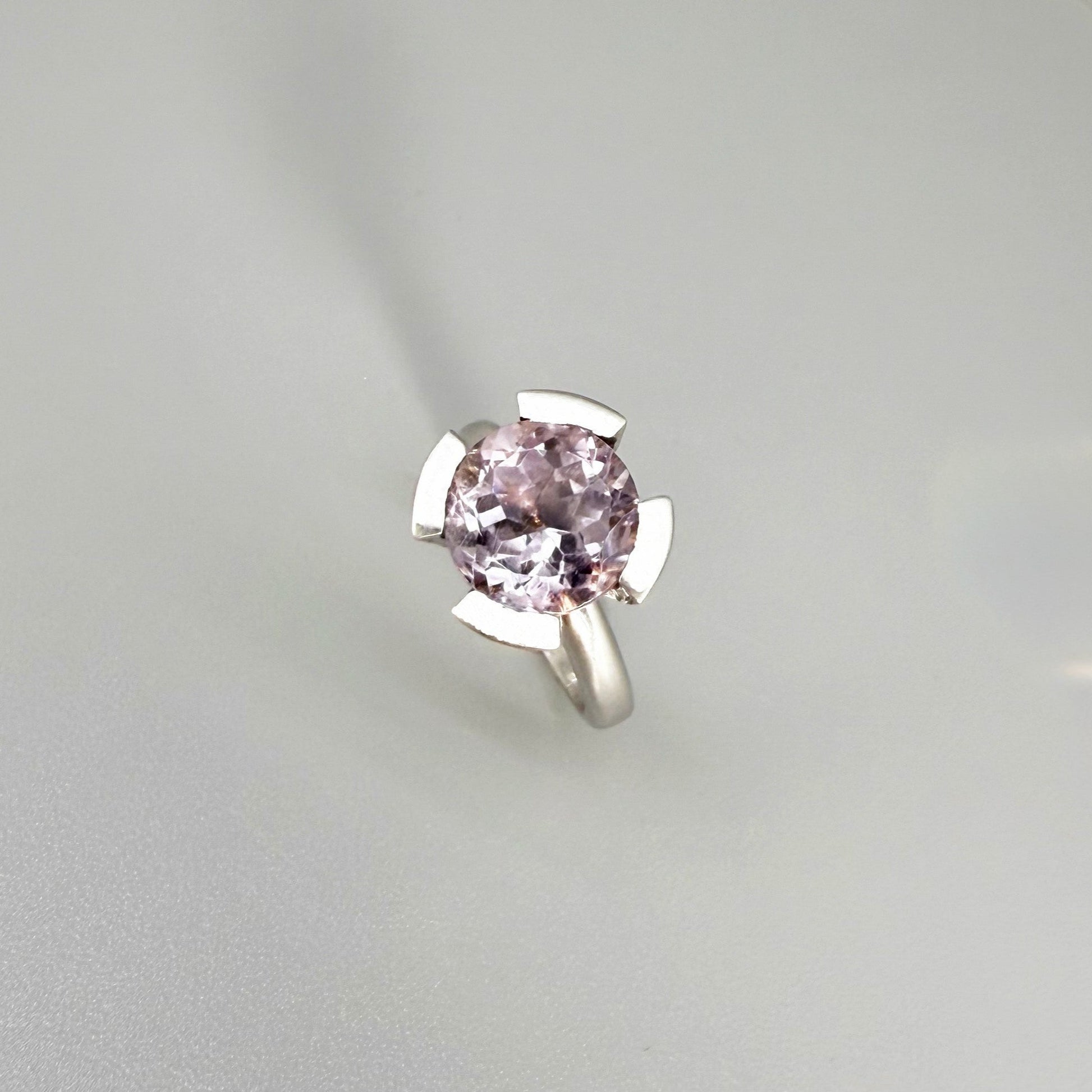 Handmade amethyst and CZ ring in white gold plated sterling silver on neutral background