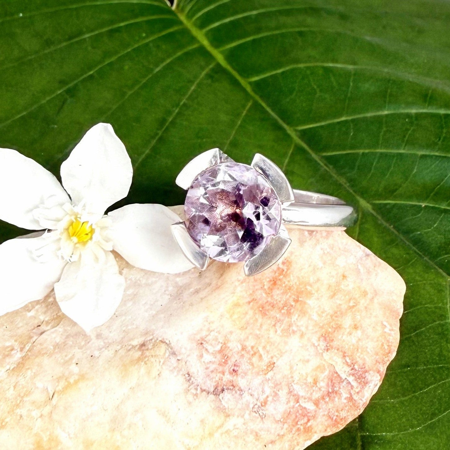Handmade amethyst and CZ ring in white gold plated sterling silver on neutral background