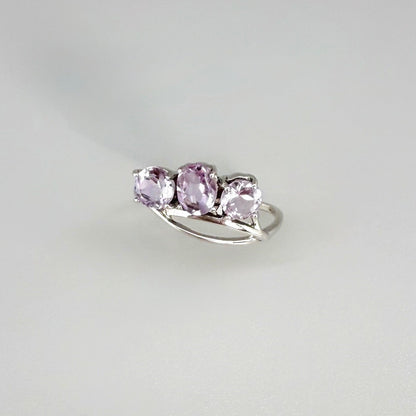 Three-stone amethyst ring in white gold plated sterling silver, featuring natural violet gemstones with soft lavender brilliance, elegant and feminine design.