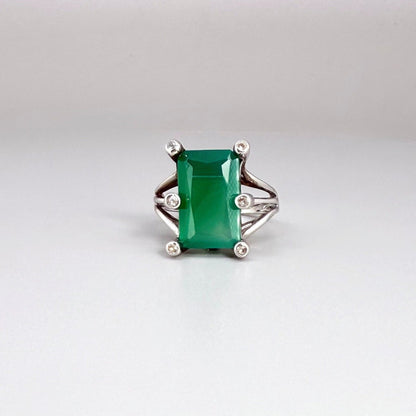 White gold plated sterling silver ring with emerald-cut green chalcedony, elegant solitaire design with soft natural glow.