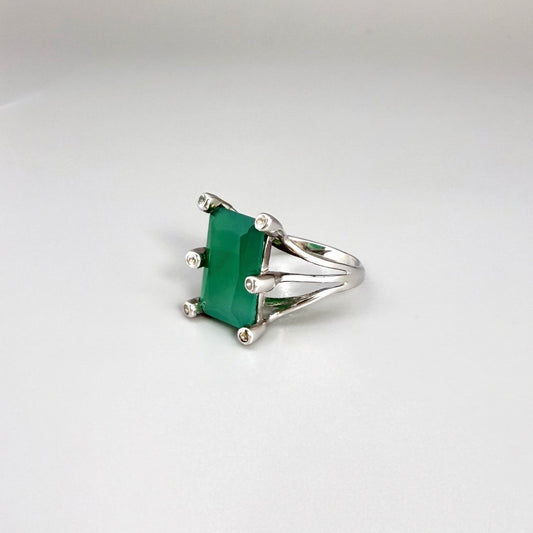 White gold plated sterling silver ring with emerald-cut green chalcedony, elegant solitaire design with soft natural glow.