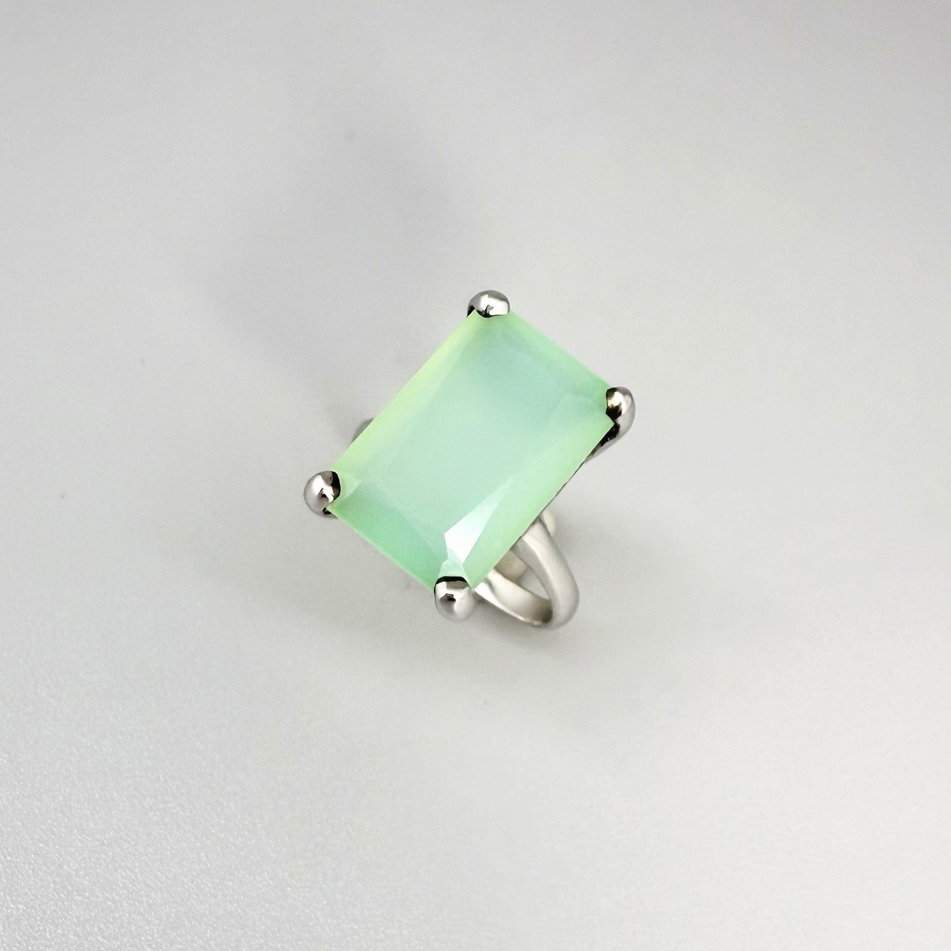 Green chalcedony ring in white gold plated sterling silver, featuring a rectangular-cut soft mint green gemstone with gentle translucence, elegant design.