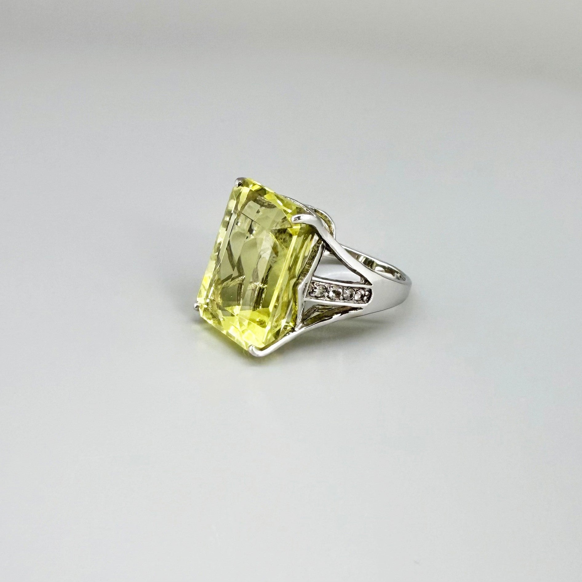 Chrysoprase and CZ ring in white gold plated sterling silver, featuring a rectangular bright green gemstone with clear cubic zirconia side accents, elegant and modern design.
