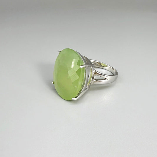 Chrysoprase ring in white gold plated sterling silver featuring an oval cabochon gemstone with light apple-green hue and smooth, natural translucence.