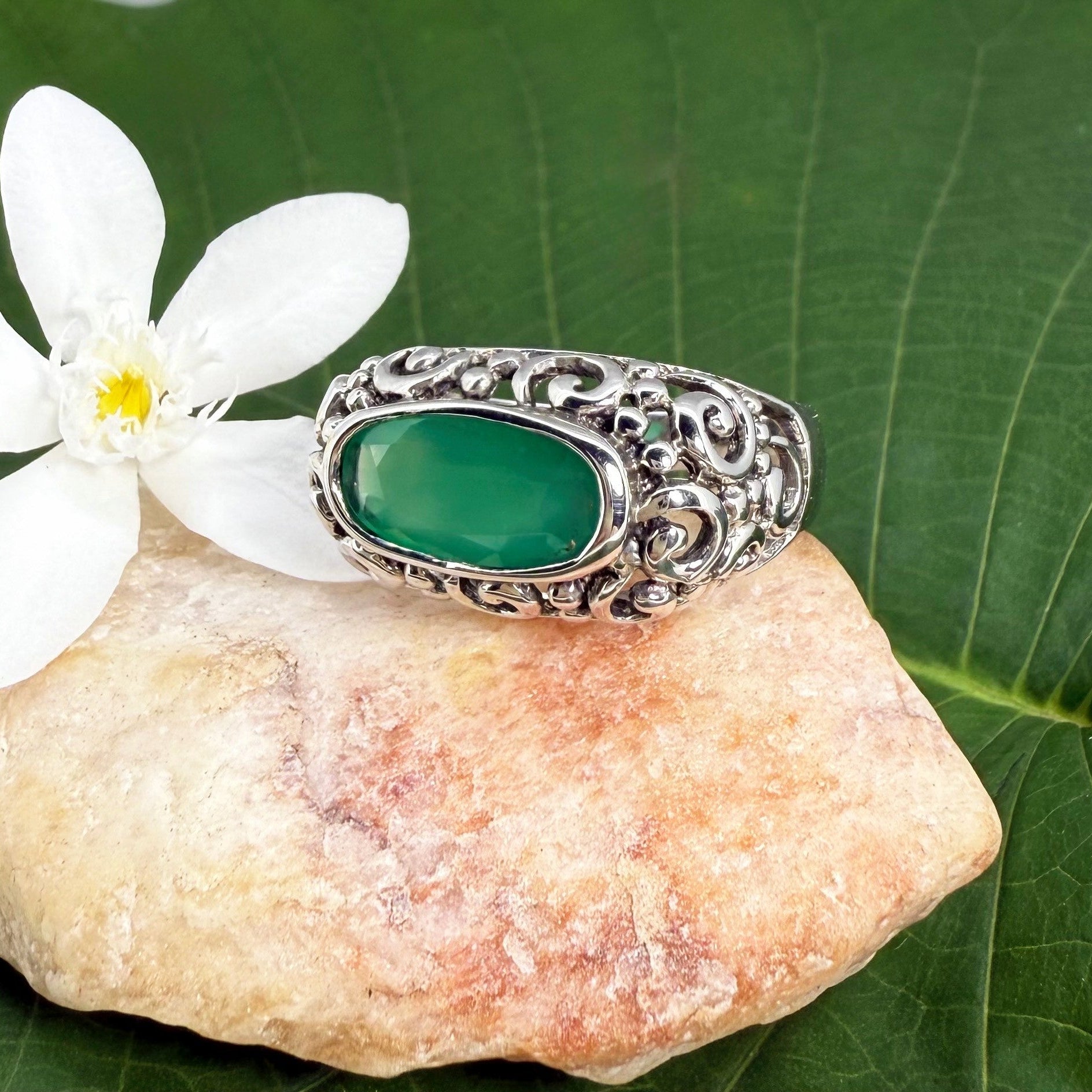 White gold plated sterling silver ring featuring an oval green chalcedony gemstone in a textured silver band.