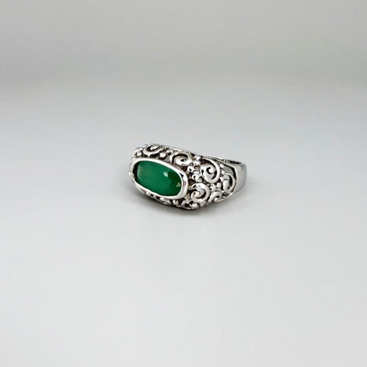 White gold plated sterling silver ring featuring an oval green chalcedony gemstone in a textured silver band.