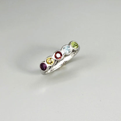 Multicolor gemstone ring in white gold plated sterling silver featuring citrine, tourmaline, rhodolite, and topaz, elegant band design with warm and cool tones.
