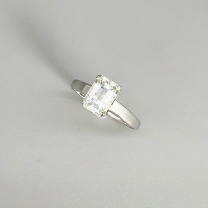 Aquamarine solitaire ring in white gold plated sterling silver, featuring a light blue natural gemstone on neutral background, elegant and timeless design.