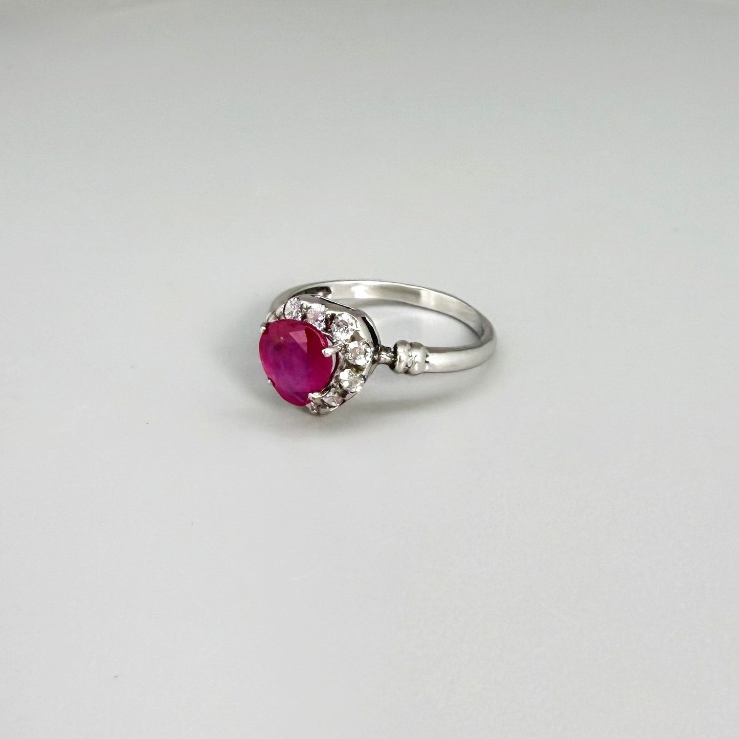 Ruby and CZ ring in white gold plated sterling silver, featuring a vivid red natural ruby with sparkling cubic zirconia accents, elegant and timeless design.
