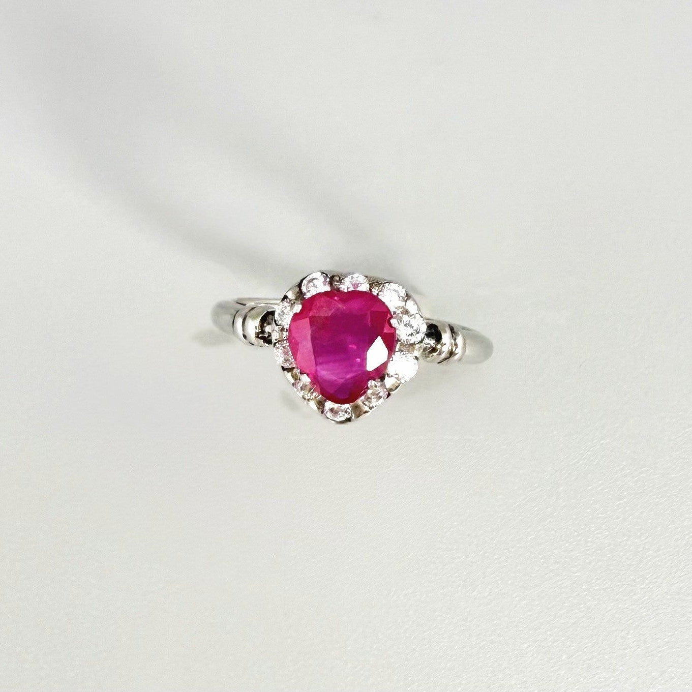 Ruby and CZ ring in white gold plated sterling silver, featuring a vivid red natural ruby with sparkling cubic zirconia accents, elegant and timeless design.