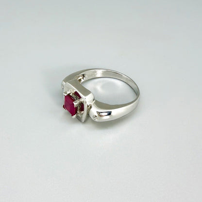 Ruby and CZ ring in white gold plated sterling silver, featuring a vivid red natural ruby framed by clear cubic zirconia, elegant and classic design.