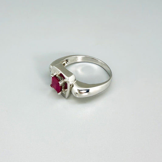 Ruby and CZ ring in white gold plated sterling silver, featuring a vivid red natural ruby framed by clear cubic zirconia, elegant and classic design.