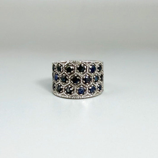 Wide band blue sapphire ring in white gold plated sterling silver featuring faceted deep blue sapphires for an elegant, timeless look.