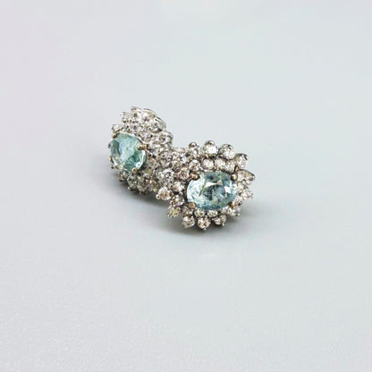 Aquamarine and cubic zirconia stud earrings in white gold plated sterling silver with butterfly backs.