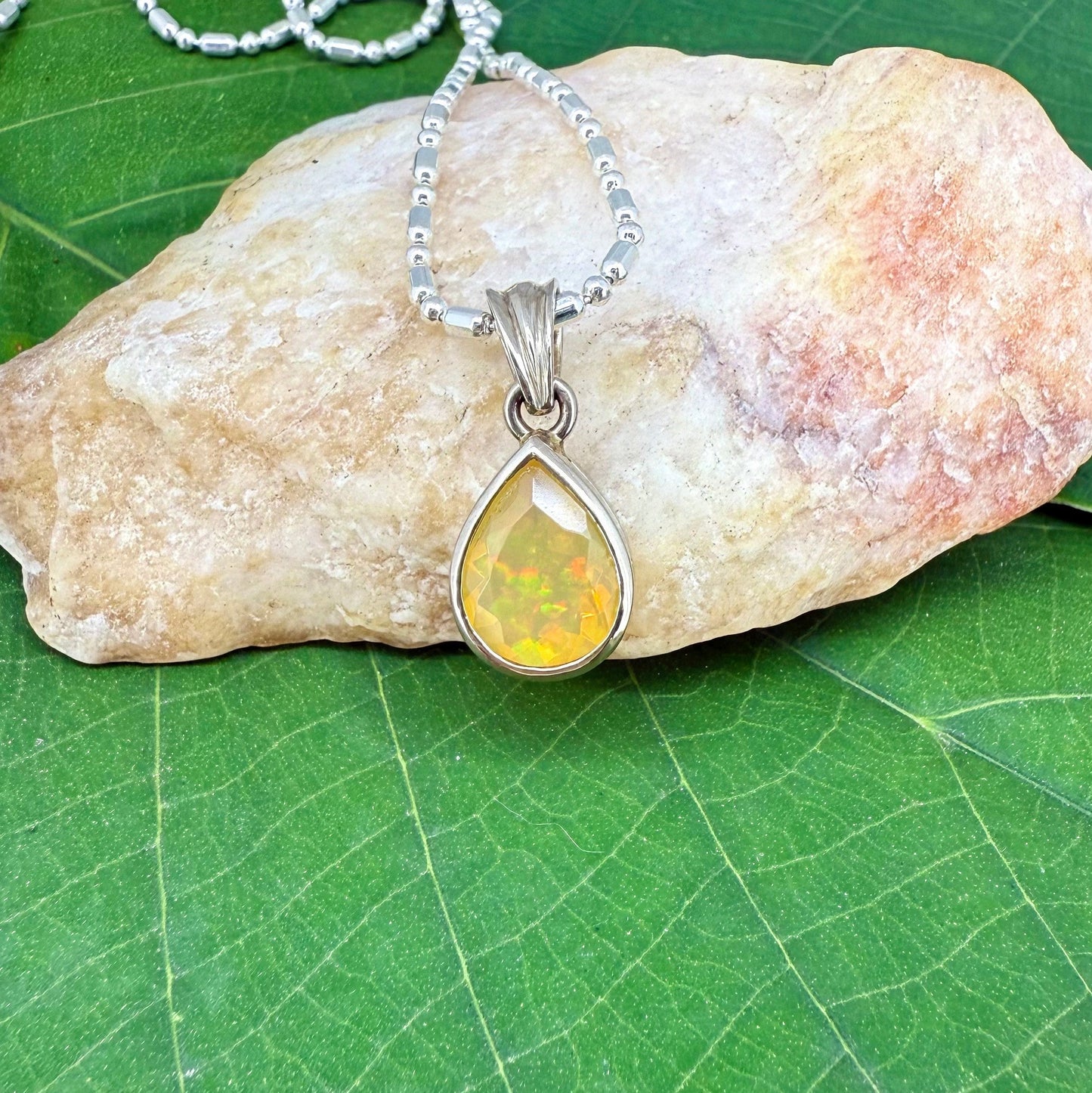 Handmade white gold plated silver pendant with 14.76 ct rose quartz and cubic zirconia accents, elegant and refined design.