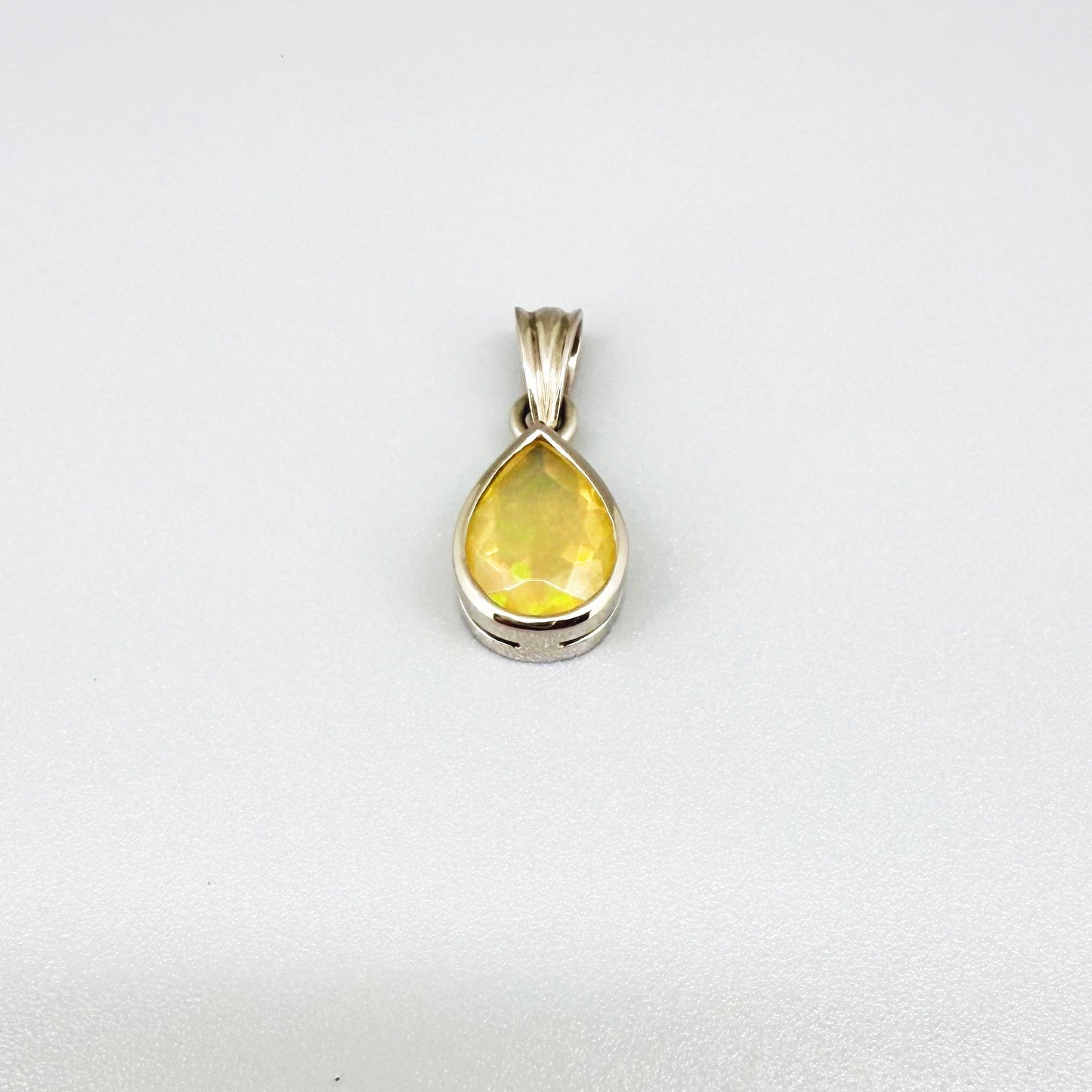 Handmade white gold plated silver pendant with 14.76 ct rose quartz and cubic zirconia accents, elegant and refined design.