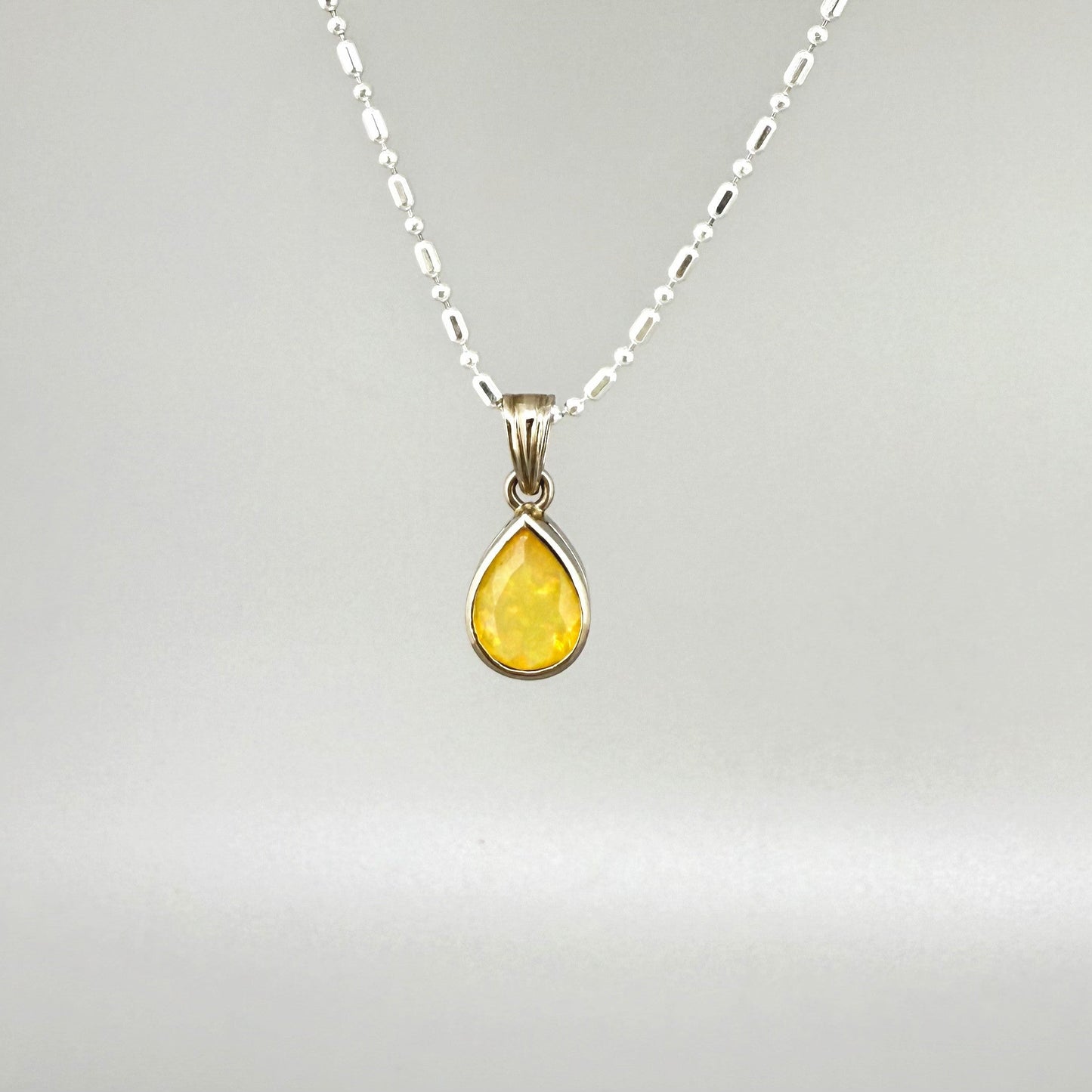 Handmade white gold plated silver pendant with 14.76 ct rose quartz and cubic zirconia accents, elegant and refined design.