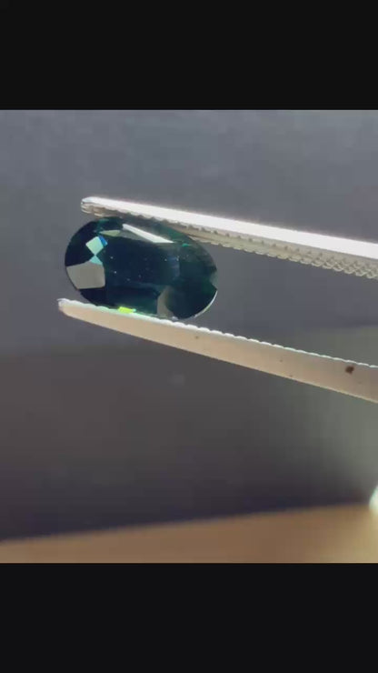 Natural heated deep teal Laos sapphire, 3.18 ct oval with eye-clean clarity and vivid blue-green flashes.
