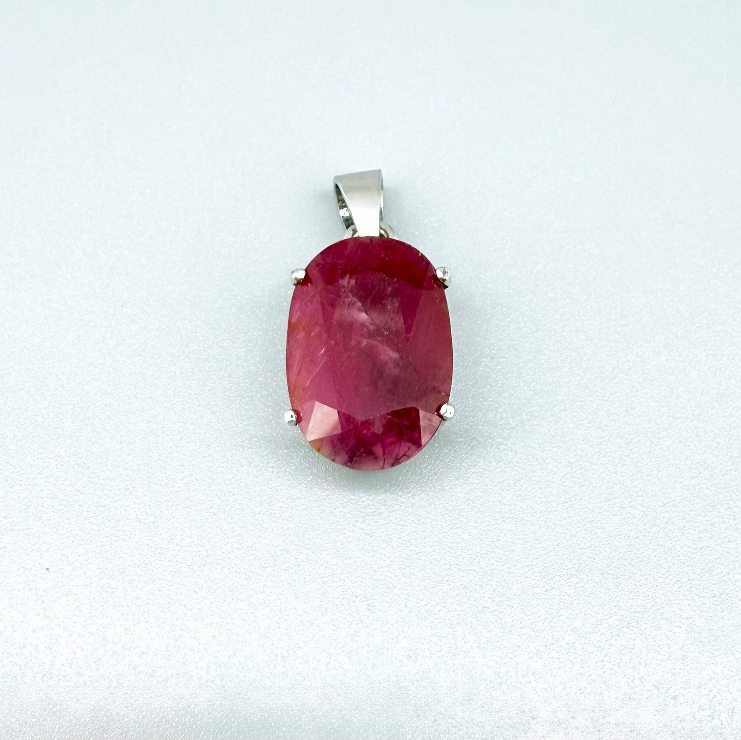 White gold plated silver pendant featuring a 17.12 ct natural ruby with deep red brilliance, handcrafted and elegant design.