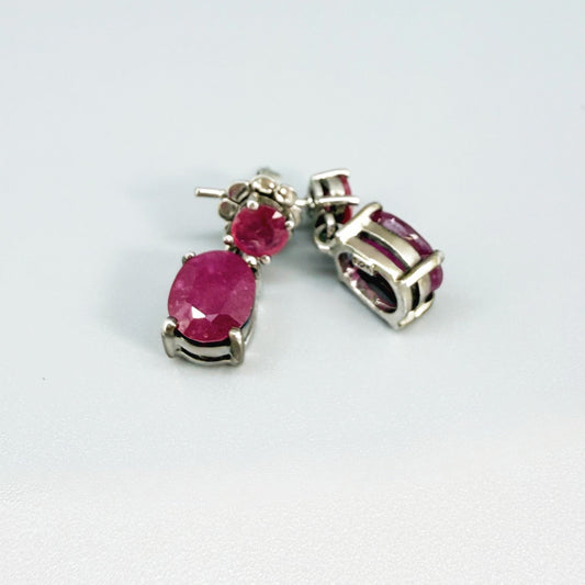 Ruby drop earrings in white gold plated sterling silver with natural pink rubies.